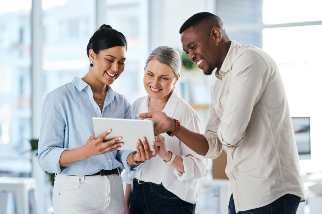Shot of a group of businesspeople using a digital tablet together in an office.